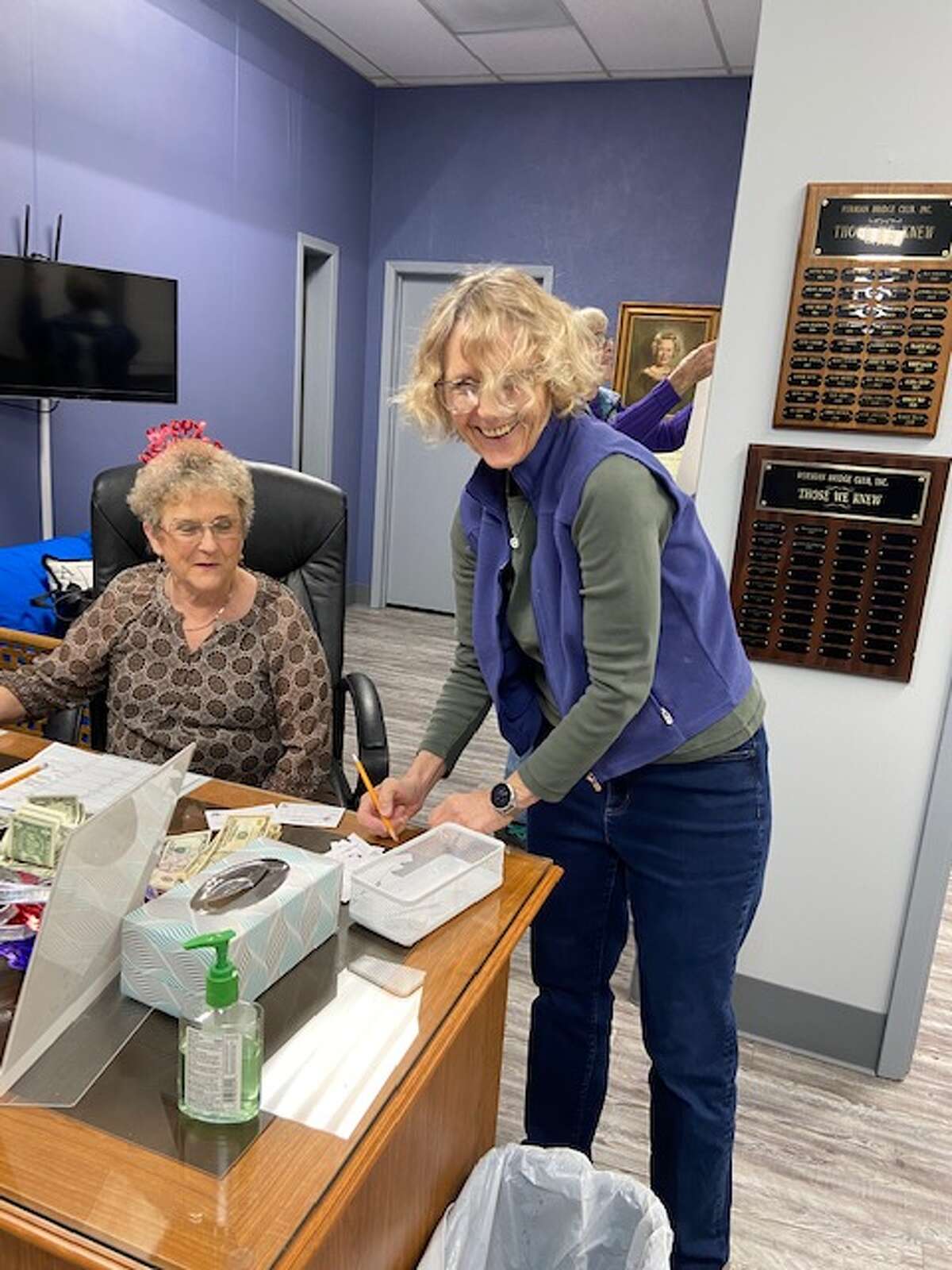 Img 1503: Nancy Ward, left, reminds Kay Sewell to sign up for a free game at the Allison Bridge Club's New Years buffet and game.