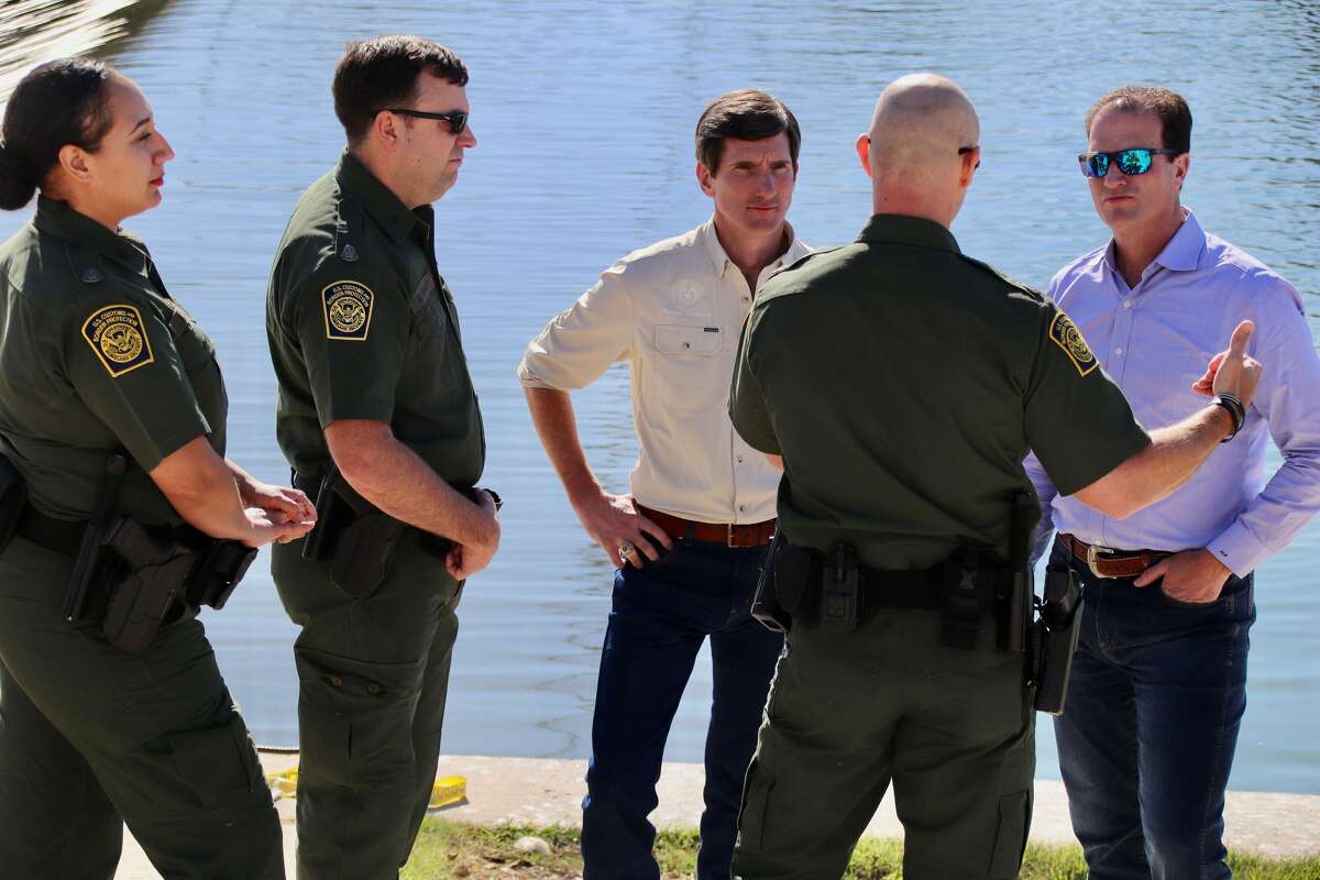 State Rep. Brooks Landgraf, center, and U.S. Rep. August Pfluger, right, listen to law enforcement officials about problems along the border