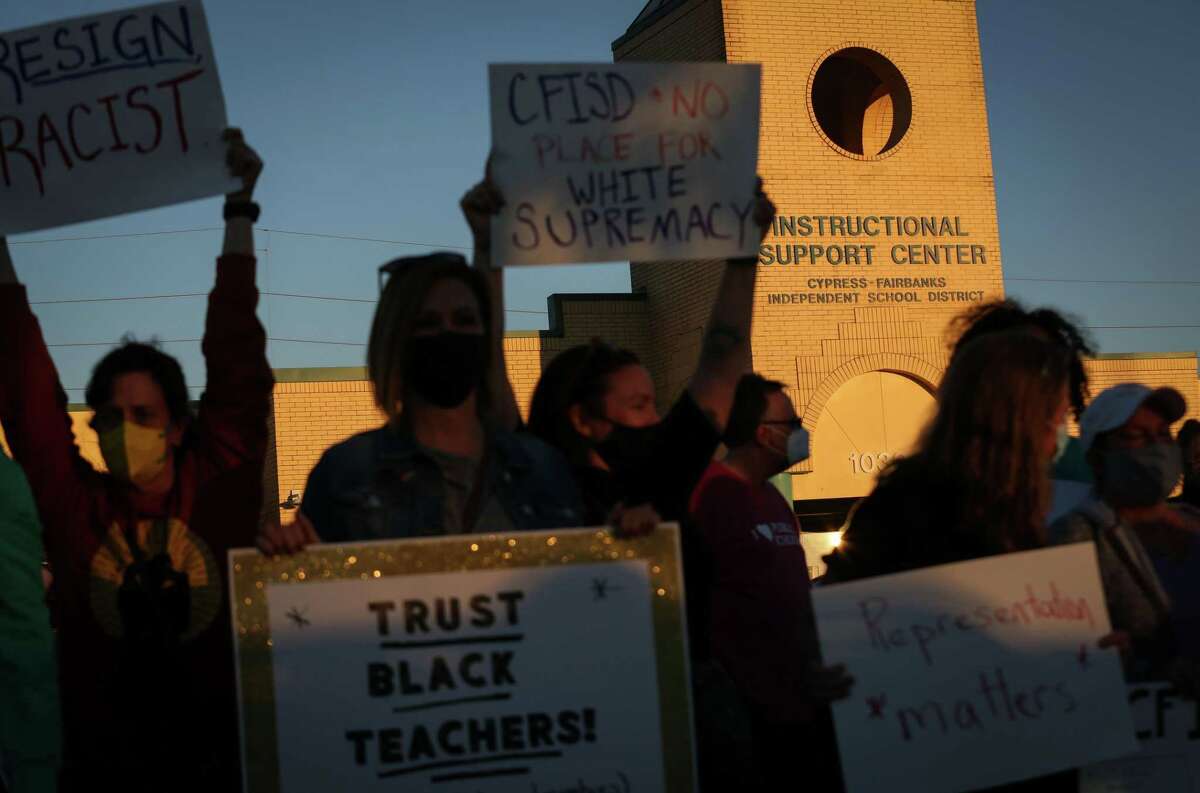 People protest outside of a Cypress-Fairbanks ISD School Board Meeting on Thursday, Jan. 13, 2022, at the CFISD Instructional Support Center in Houston.