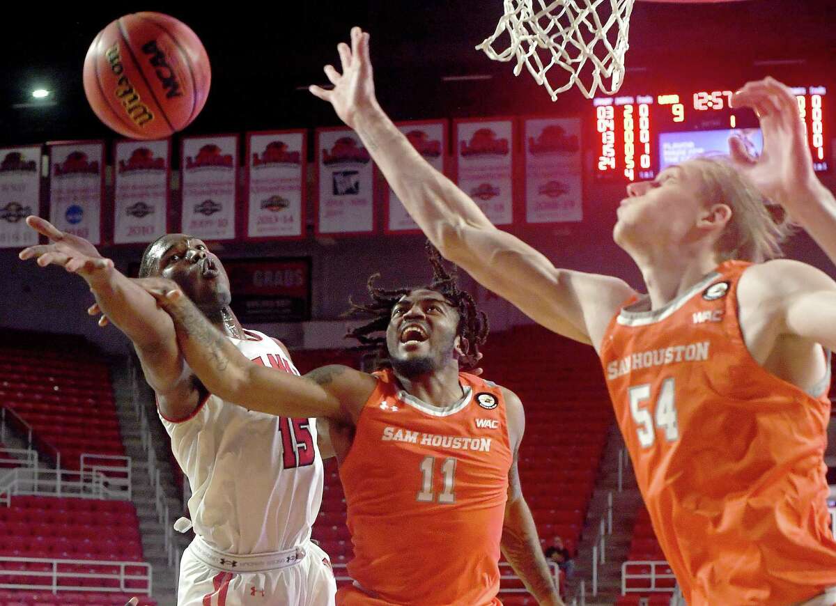 Lamar's Deiman Reyes battles for the rebound with Sam Houston State's Javion May and Kuba Karwowski during Thursday's game at the Montagne Center. Photo made Thursday, January 13, 2022 Kim Brent/The Enterprise