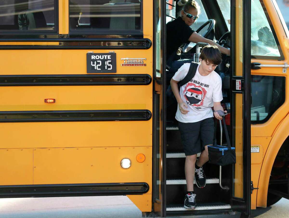 Sixth grader Hayden Fusca gets off a school bus in front of his home, Thursday, Jan. 13, 2022, in Spring. Fusca’s parents are suing Conroe ISD for allegedly violating his rights under the Individuals with Disabilities Education Improvement Act by not providing him with the necessary accommodations and services for autism and dyslexia.