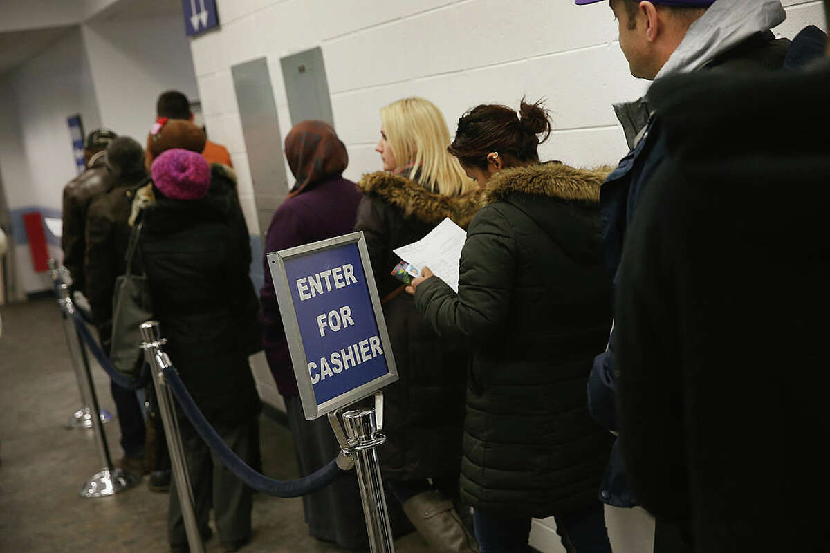 Illinois residents wait in line at a driver services facility on Dec. 10, 2013. (Photo by Scott Olson/Getty Images)
