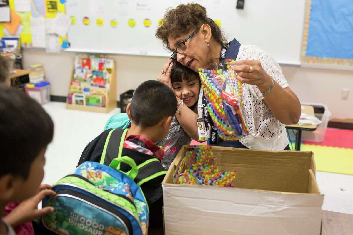 Teresa Guerrero hugs her first grade student Jacquiline Herrera, 7, on her last day of school before retiring from Gilbert Elementary School in Harlandale ISD on June 2, 2016 in San Antonio, Texas. She was a teacher at the school for 40 years.