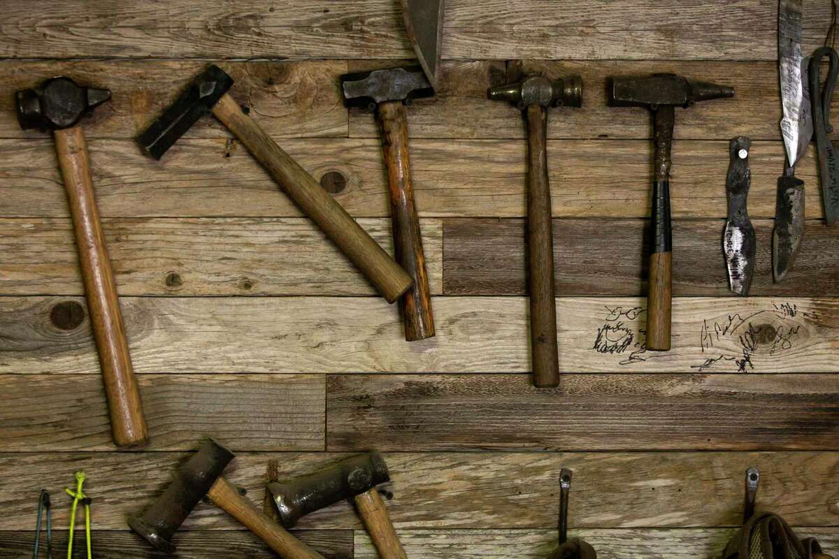 Tools hang on the wall of the Reforged workshop.