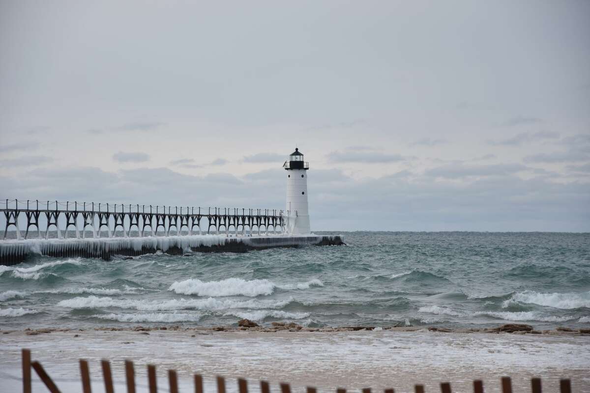 The waves were active and the ice was accumulating along Fifth Avenue Beach in Manistee on Friday. 