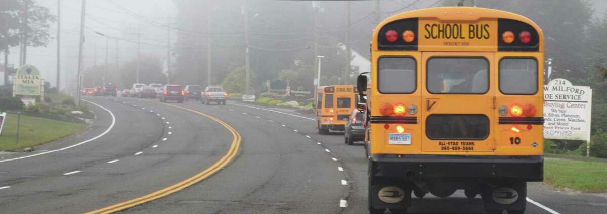Spectrum/New Milford students headed back to school Tuesday, Aug. 27, 2019. A familiar scene once the school year starts, traffic backs up along Route 7 in front of Italia Mia so a bus can pick up students at Willow Springs near the Windmill Diner ahead.