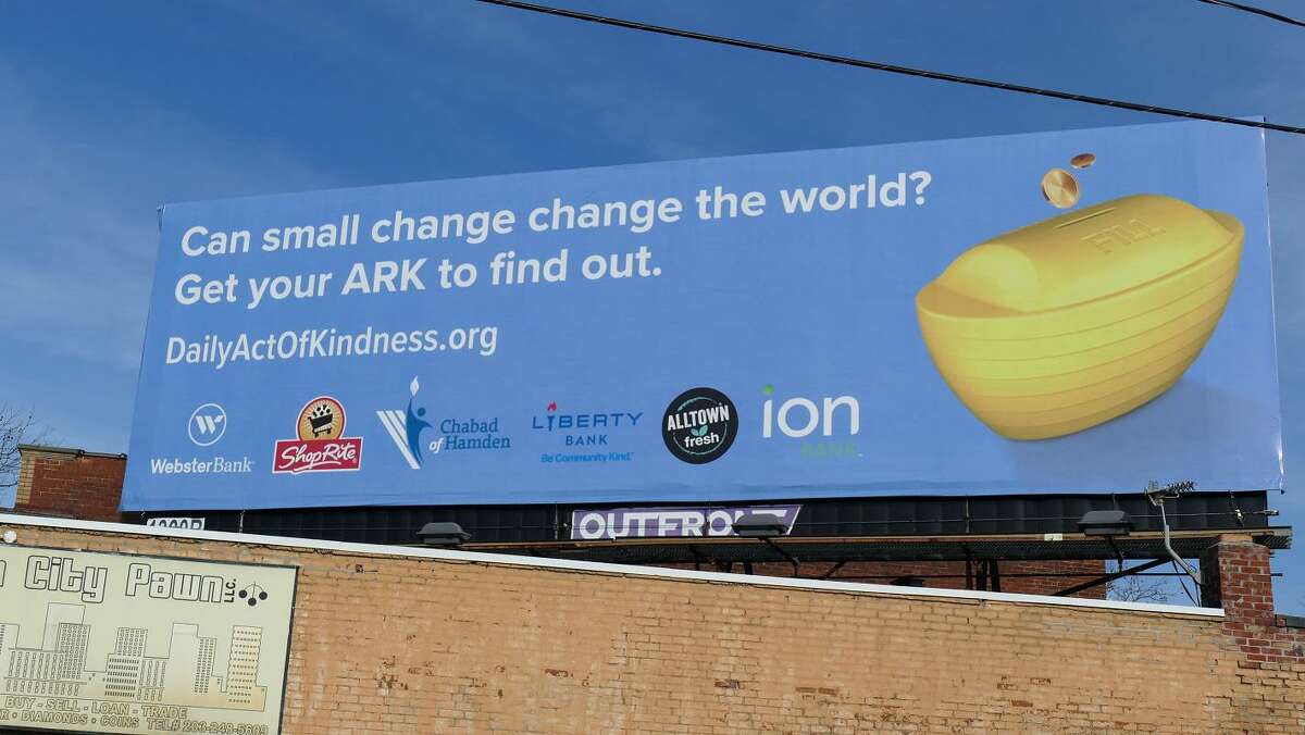 A billboard advertises a kindness and giving initiative brought to Hamden by Rabbi Moshe Hecht.