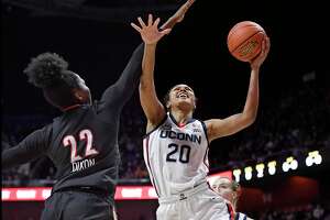 UConn’s Olivia Nelson-Ododa (20) is fouled by Louisville’s Liz Dixon in the first half on Dec. 19.