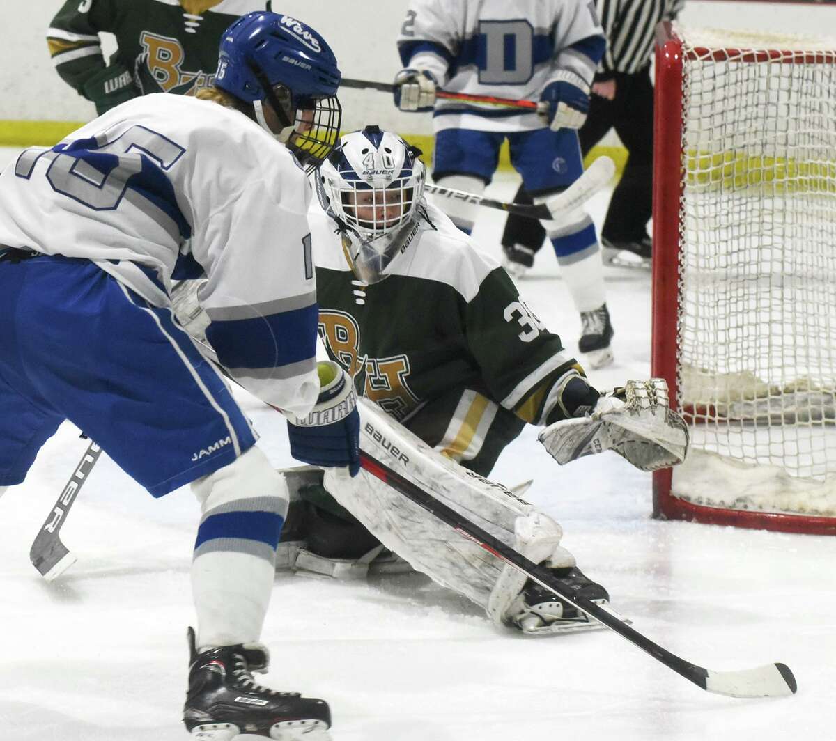 Bishop Hendricken goalie Colin Murray protects the net against a shot from Darien’s Billy Branca (15) during a game last Saturday.