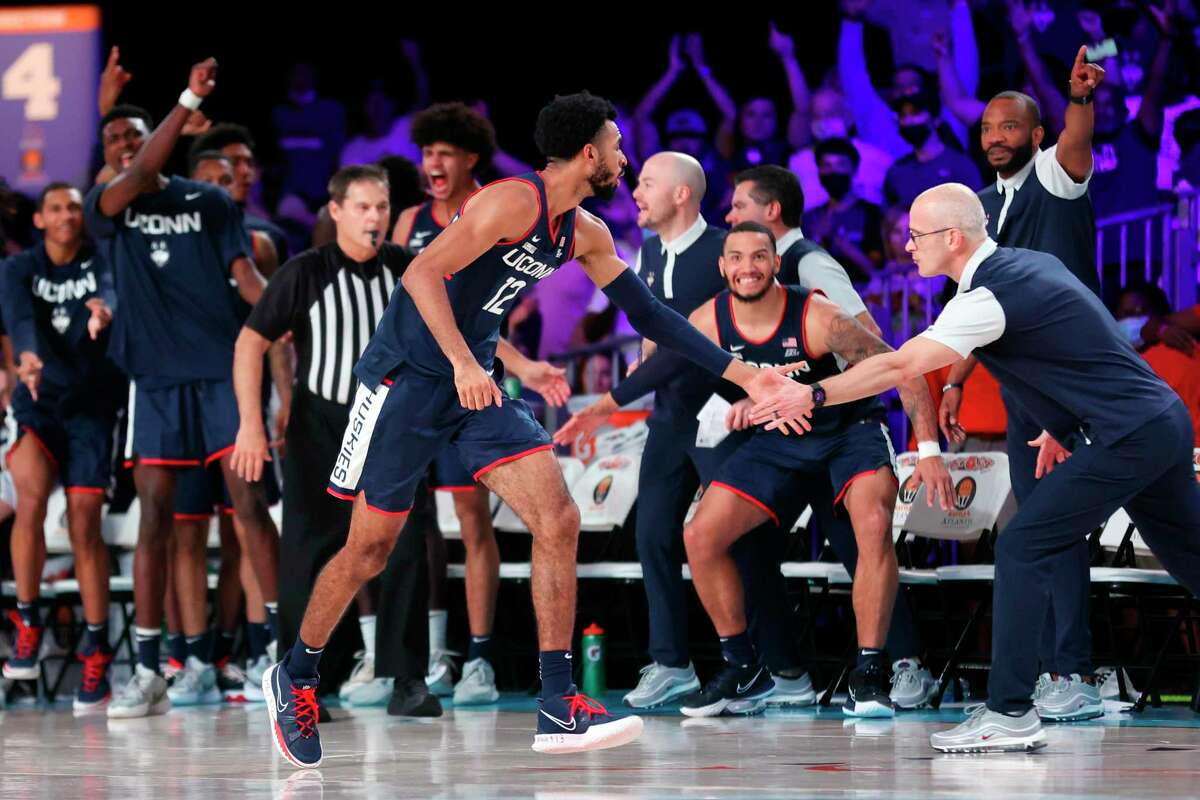 UConn forward Tyler Polley (12) is congratulated by coach Dan Hurley after making a 3-point basket against Auburn in the second overtime of an NCAA college basketball game at Paradise Island, Bahamas, Wednesday, Nov. 24, 2021.