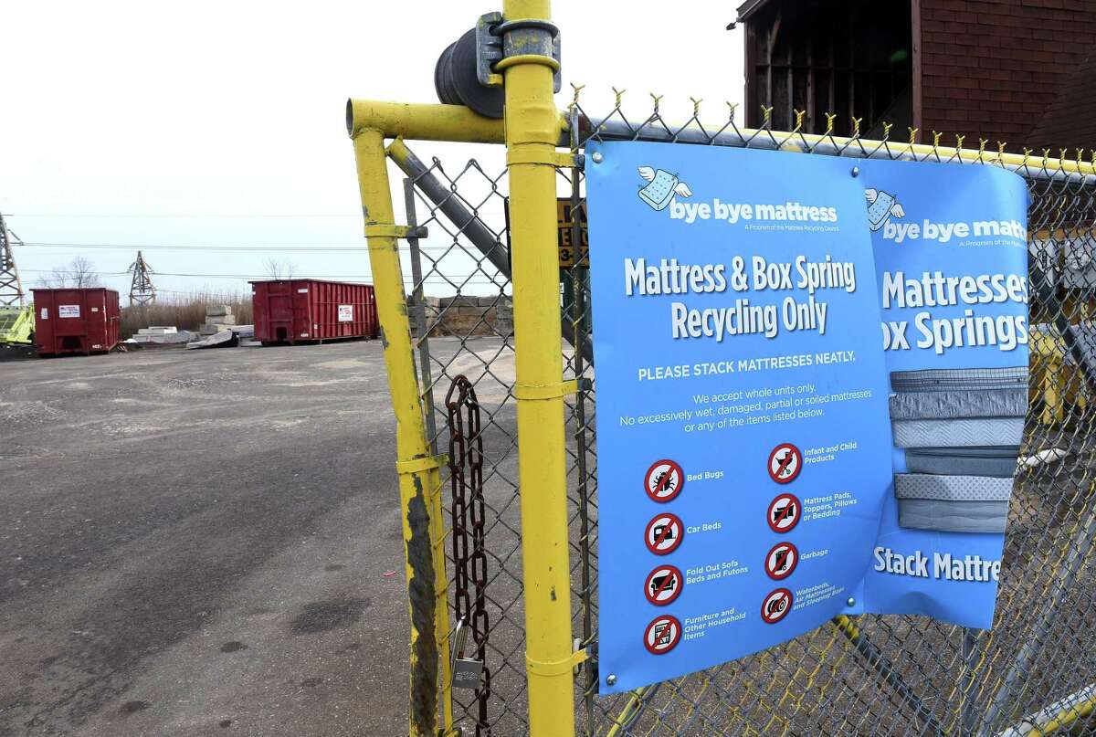 Signs about mattress and box spring recycling are displayed at the Public Works Department on Collis Street in West Haven Jan. 14, 2022.