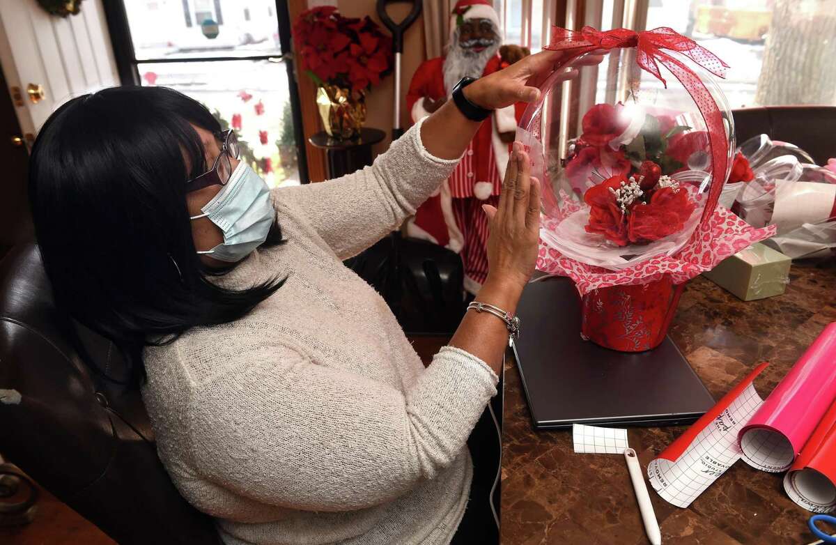 Simone Darby, owner of Charice’s Creations, works on a balloon flower bouquet for Valentine’s Day at her home in New Haven Jan. 13, 2022.