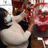 Simone Darby, owner of Charice’s Creations, works on a balloon flower bouquet for Valentine’s Day at her home in New Haven Jan. 13, 2022.
