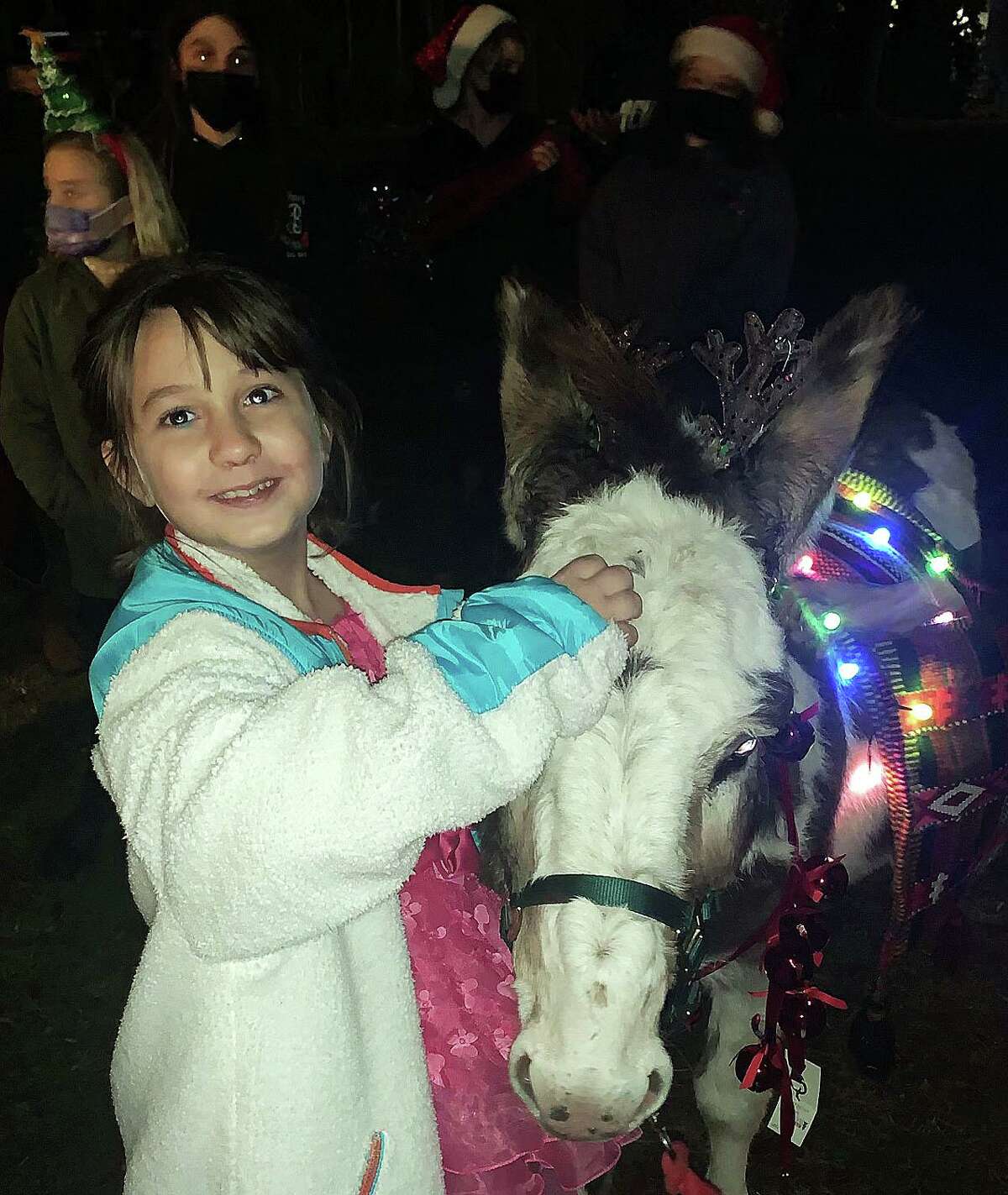 Thanks to a collaboration between Powder Ridge Ski Patrol and Hearts healed by horses in Durham, Evie Forchielli got to ride a reindeer donkey in her front yard.