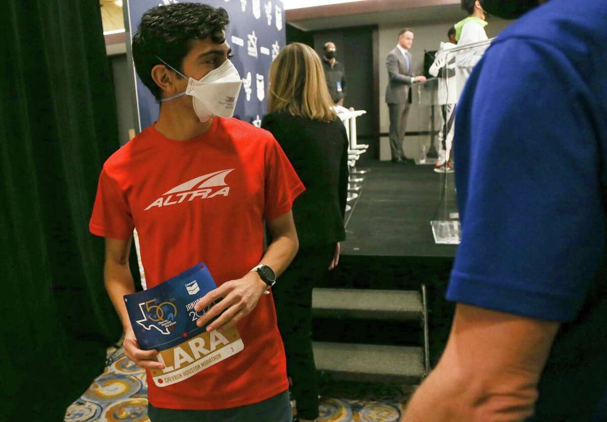 2022 Chevron Houston Marathon participant Frank Lara leaves the stage after a press conference at the Hilton-Americas in Houston on Friday, Jan. 14, 2022. Lara, who was raised in Houston, will be competing in his first marathon.
