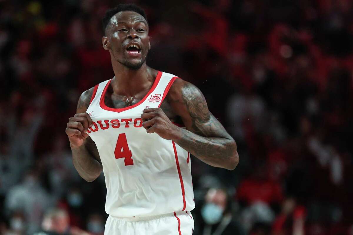 Houston guard Taze Moore (4) celebrates the Cougars’ 76-66 win over Wichita State in an NCAA basketball game Saturday, Jan. 8, 2022, in Houston.