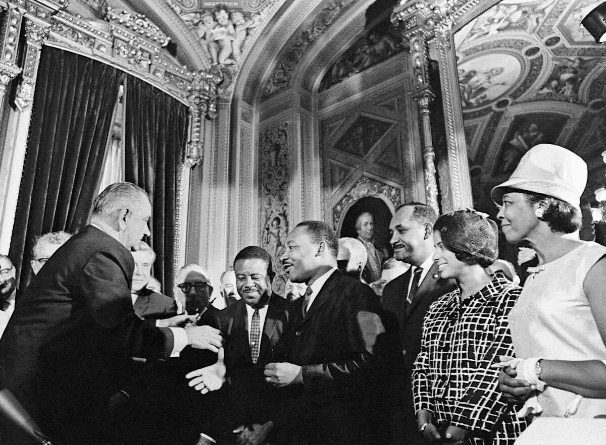 President Lyndon Johnson and Martin Luther King Jr. celebrate the signing of the Voting Rights Act on Aug. 6, 1965. King’s peaceful protests were instrumental in the law’s passage.