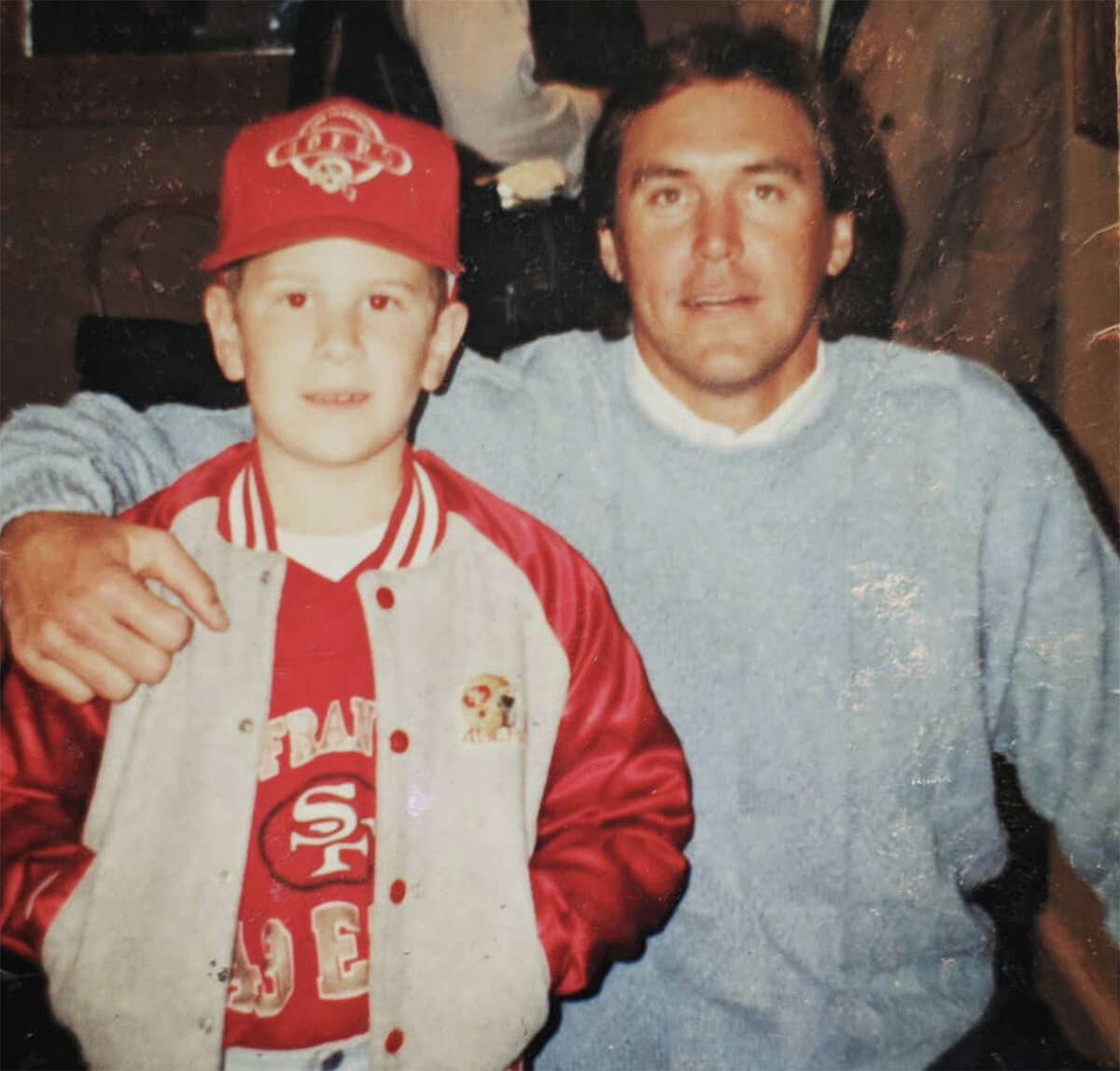 Dwight Clark poses for a photo with young Redwood City resident and 49ers fan James Leonard, who often got to go to Clark's By the Bay whenever he got a good report card at school. 