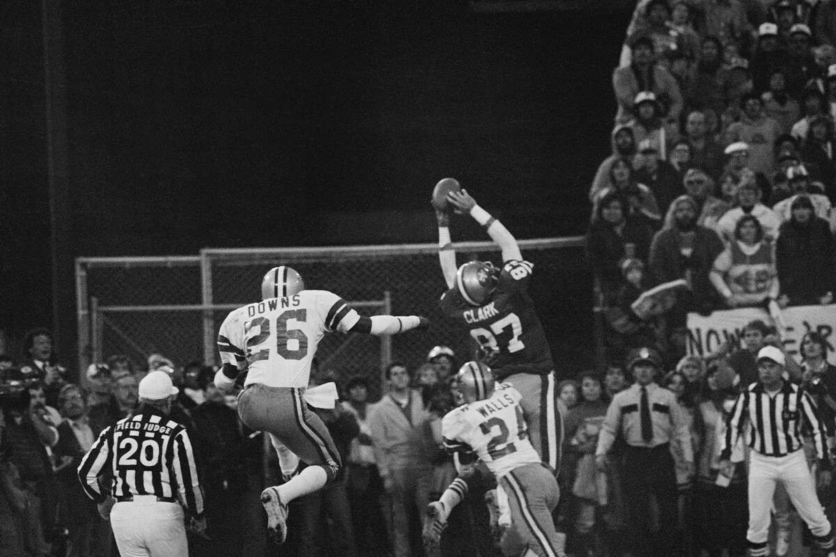 San Francisco 49ers wideout Dwight Clark goes up in the air in the end zone for the game-tying touchdown pass from Joe Montana, famously known as the "The Catch," that would defeat the Dallas Cowboys in the 1981 NFC championship game.