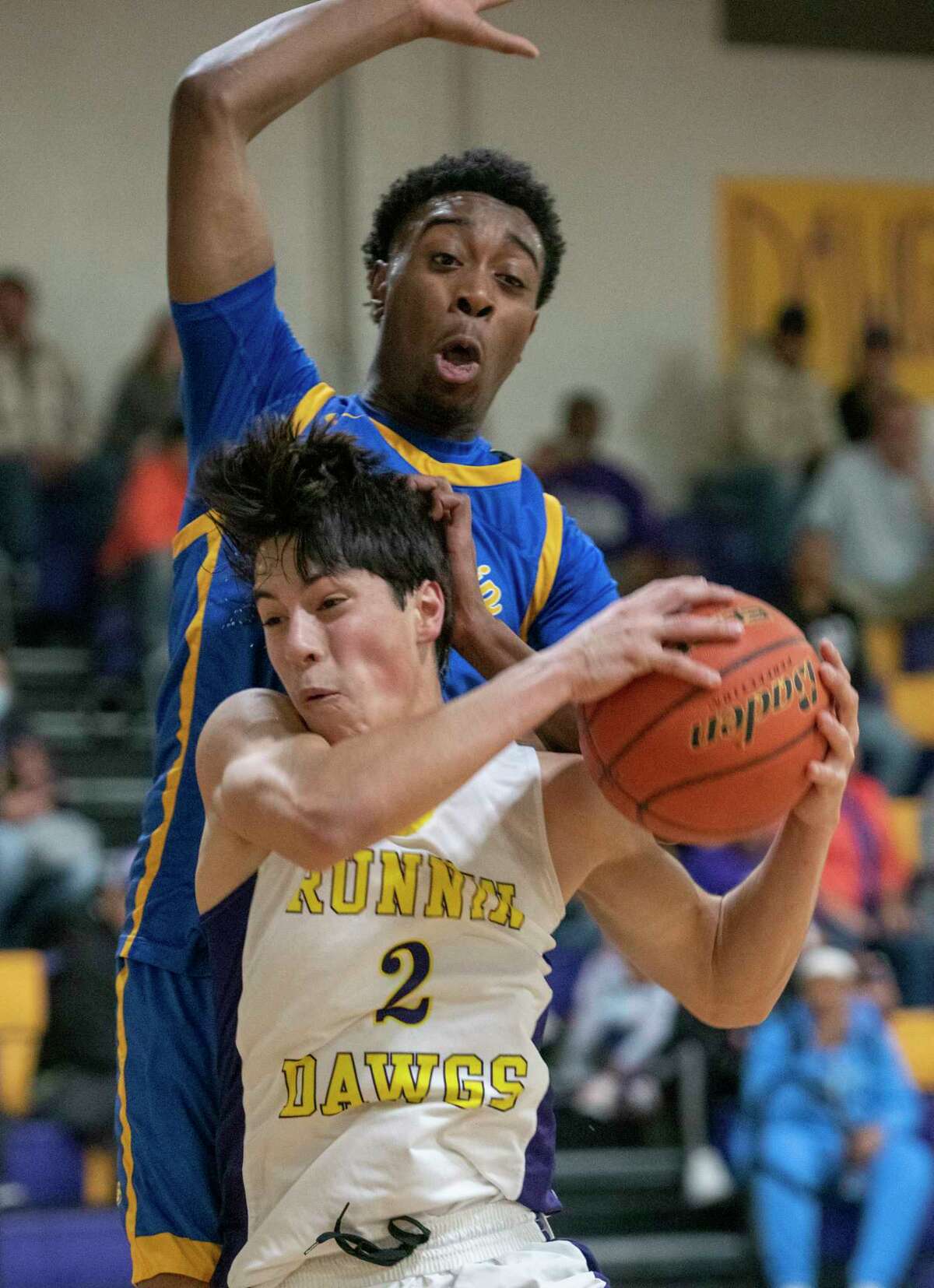 Midland High's Santiago Salcedo draws the foul of Frenship's Tajavis Miller as he attempts a layup 01/14/2022 at Midland High gym. Frenship went on to win 55-32. Tim Fischer/Reporter-Telegram