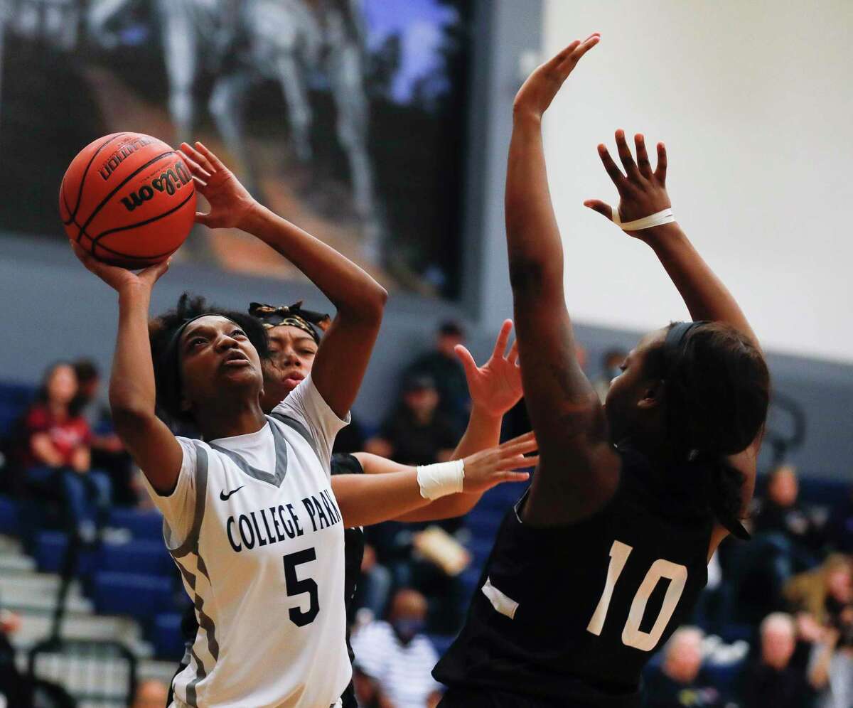 College Park shooting guard Hannah Moore (5) shoots over Willis center Seriah Davis (10) during the first quarter of a District 13-6A high school basketball game at College Park High School, Friday, Jan. 14, 2022, in The Woodlands.
