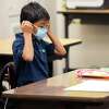 Second grader Ernesto Beltran Pastrana puts on his face mask at Garfield Elementary School in Oakland in March.