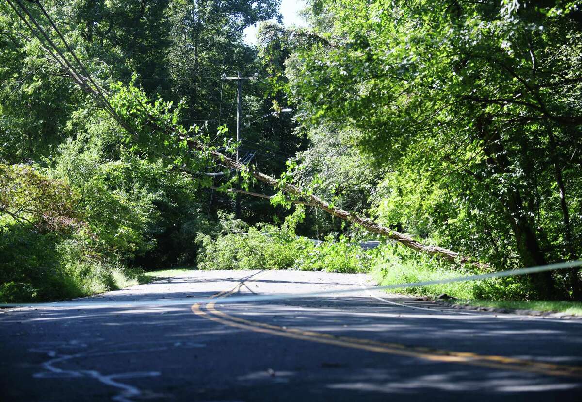 A tree and powerlines are down on Rocky Rapids Road the day after the remnants of Hurricane Ida hit the area with heavy rain and wind in Stamford on Sept. 2, 2021. More than 1,300 people were without power Friday night as the state braces for frigid temperatures.