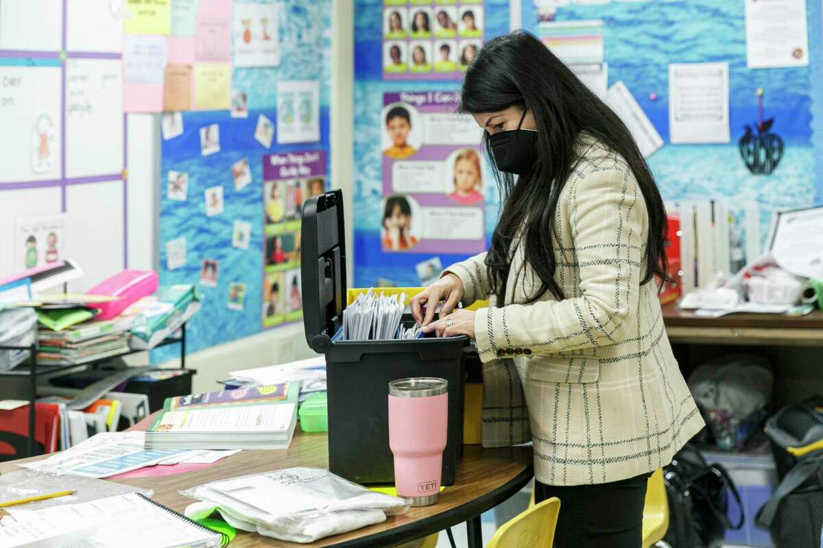 Jennifer Gutierrez looks through the lesson plans at Larkspur Elementary School on Wednesday. The North East ISD administrator filled in as a substitute for an absent second grade teacher.