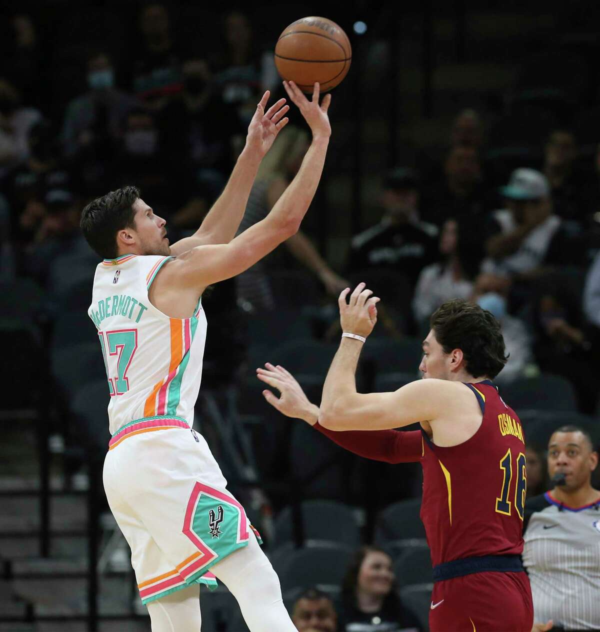 Spurs' Doug McDermott (17) hoists a three against Cleveland Cavaliers' Cedi Osman (16) in the first half at the AT&T Center on Friday, Jan. 14, 2022.