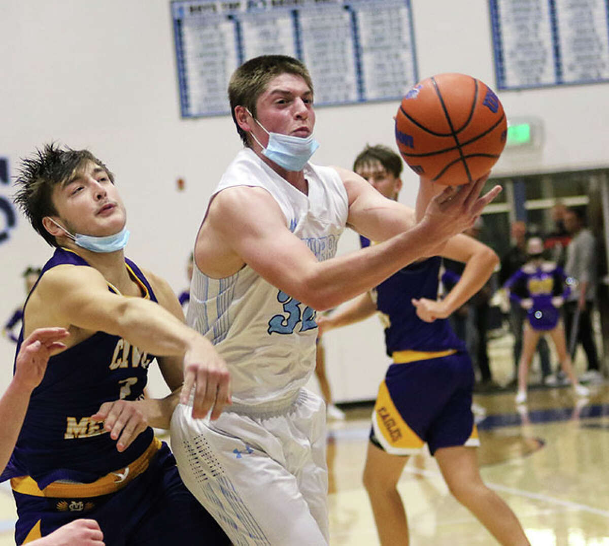 Jersey's Sam Lamer tries to retain control of the ball while going to the basket against CM's Logan Turbyfill (left) during a Dec. 3 game in Jerseyville. Lamer had six points in the Panthers' win over CM on Friday in Bethalto. 