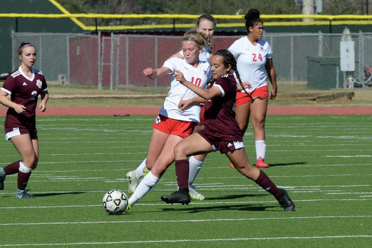 Chelsea Cross (10) of Manvel is challenged by Cecilia Escobar (23) of CyFair during the second half of a match in the I-10 Shootout between Manvel and Cy Fair Thursday at Cinco Ranch High School.