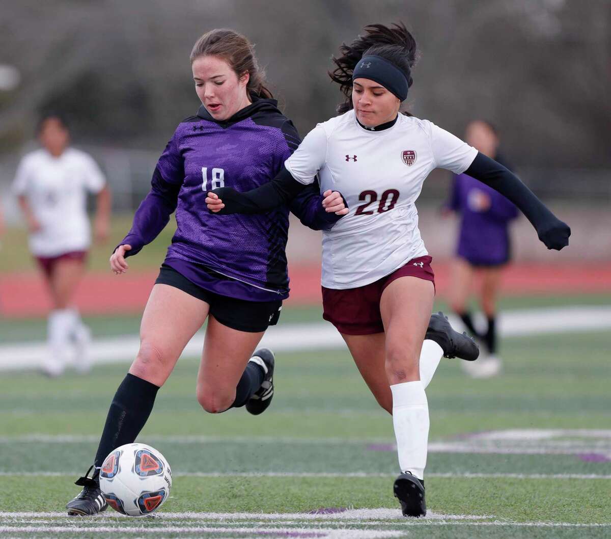 Willis’ Lucyna Smith (18) battles with Magnolia West’s Karina Sosa (20) for the ball in the first period of a high school soccer match during the Willis Kat Cup soccer tournament, Saturday, Jan. 15, 2022, in Willis.