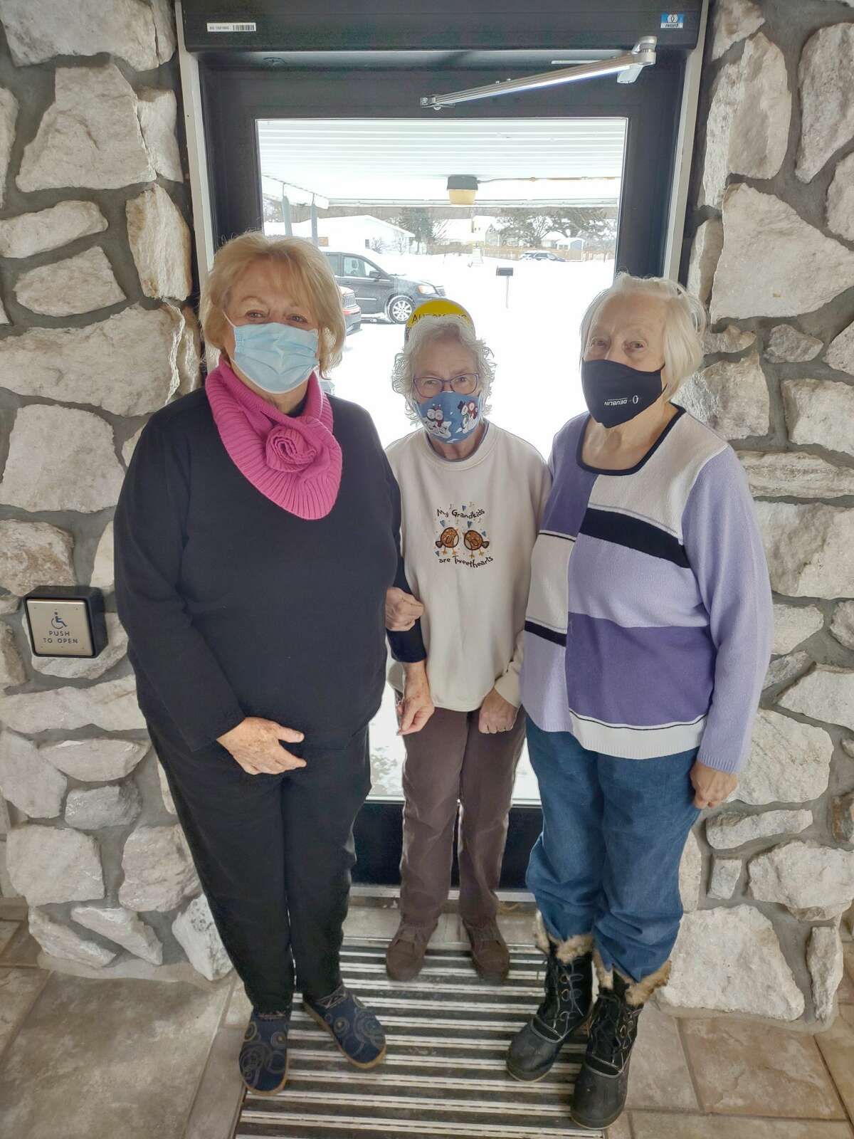 Pat Murdock, Susie Tritten, Dawn McLamb share the new doors that were installed at the Wagoner Community Center.  The cost of the doors was covered in part by 100 Women Who Care Manistee County and the craft fair hosted by the Manistee County Council on Aging during Sleighbell weekend in  December 2021.