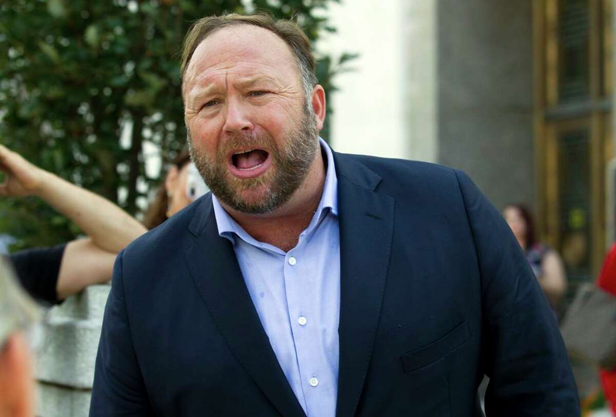 FILE- In this Sept. 5, 2018, file photo Infowars host Alex Jones speaks outside of the Dirksen building of Capitol Hill in Washington. (AP Photo/Jose Luis Magana, File)