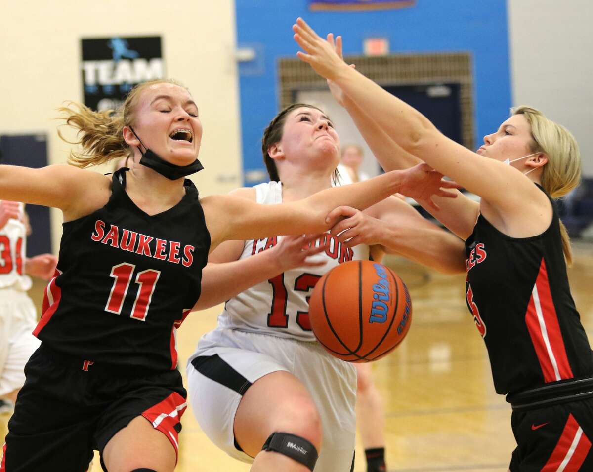 Calhoun's Ella Sievers (middle) draws a foul from Pittsfield's Tori Waters (11) while the Saukees' Shelby Bauer also contests the shot in the title game of the North Greene Lady Spartan Classic on Saturday afternoon in White Hall.