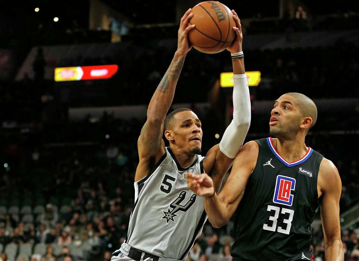 San Antonio Spurs guard Dejounte Murray #5 drives on Los Angeles Clippers Nicolas Batum #33 on Saturday, Jan. 15, 2022 at AT&T Center.