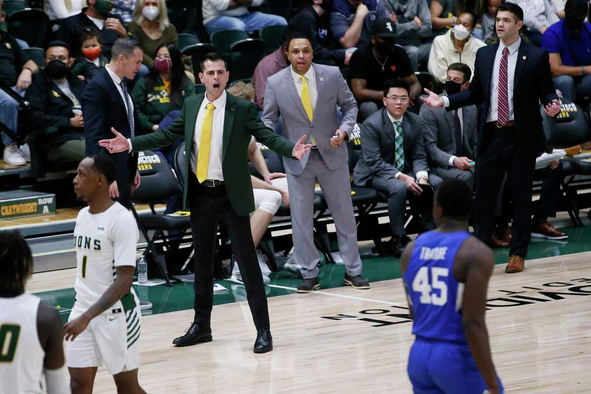 San Francisco Dons head coach Todd Golden and the bench react to the referee’s whistle in the first half of an NCAA men’s basketball game against the Brigham Young University Cougars at Memorial Gym, Saturday, Jan. 15, 2022, in San Francisco, Calif.