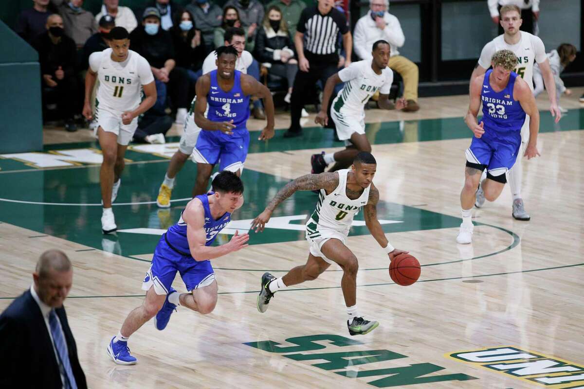 San Francisco Dons guard Khalil Shabazz (0) breaks away from the Brigham Young University Cougars and scores a two-point field goal in the first half of an NCAA men’s basketball game at Memorial Gym, Saturday, Jan. 15, 2022, in San Francisco, Calif.