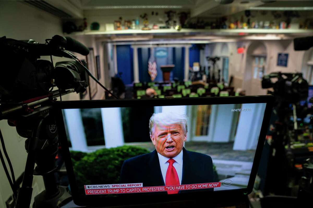 Then-President Donald Trump's recorded message to rioters is seen on a television screen in the White House briefing room as supporters are removed from the Capitol building, on Jan. 6, 2021, in Washington, DC.
