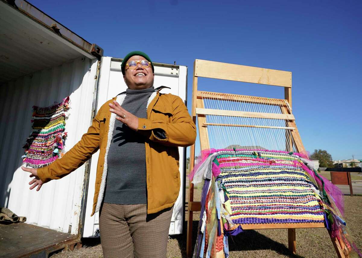 Matt Manalo, right, talks about the community loom at the Alief Art House that is in shipping containers on the grounds of the Alief Community Garden at the Alief SPARK Park and Nature Center shown Thursday, Jan. 13, 2022 in Houston.