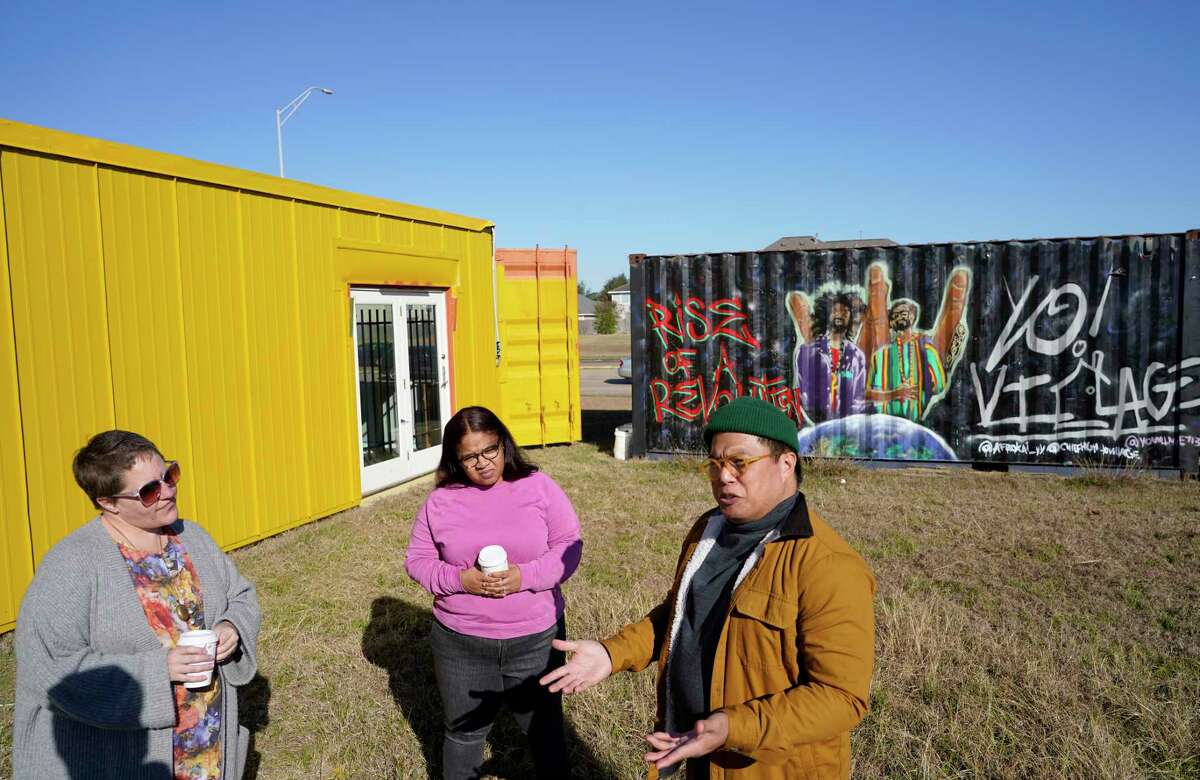 Ceci Norman, left, Vanessa Lipscomb, center, and Matt Manalo talk about the Alief Art House that is in shipping containers on the grounds of the Alief Community Garden at the Alief SPARK Park and Nature Center shown Thursday, Jan. 13, 2022 in Houston.