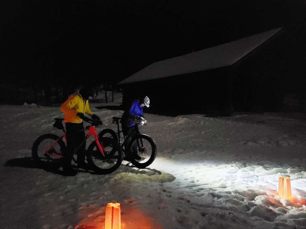Wayne Stroope and Sue Stroope gear up for a fat tire bike run through Big M's trail system on Jan. 16, 2022 during a moonlight winter sporting gathering. 
