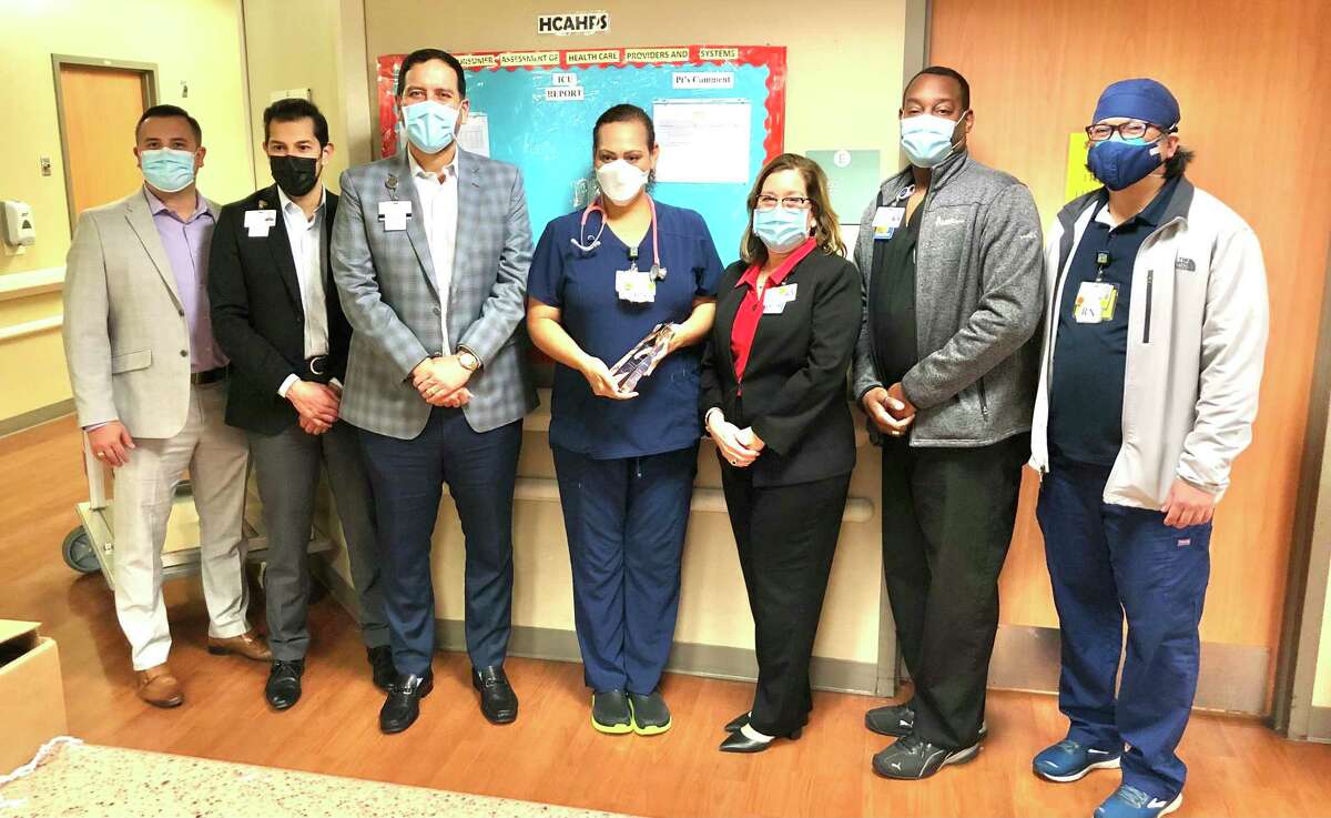 Laredo Medical Center administrators congratulate ICU RN Maria Luisa Silva for receiving the hospital’s second Nursing Excellence Award. They are, left to right, Assistant Administrator Marco Lozano, Chief Operating Officer Gerardo Ramos, Chief Executive Officer Jorge Leal, Maria Luisa, Chief Nursing Officer Cynthia Puente and Assistant Chief Nursing Officer Joseph Clark-Thrower.
