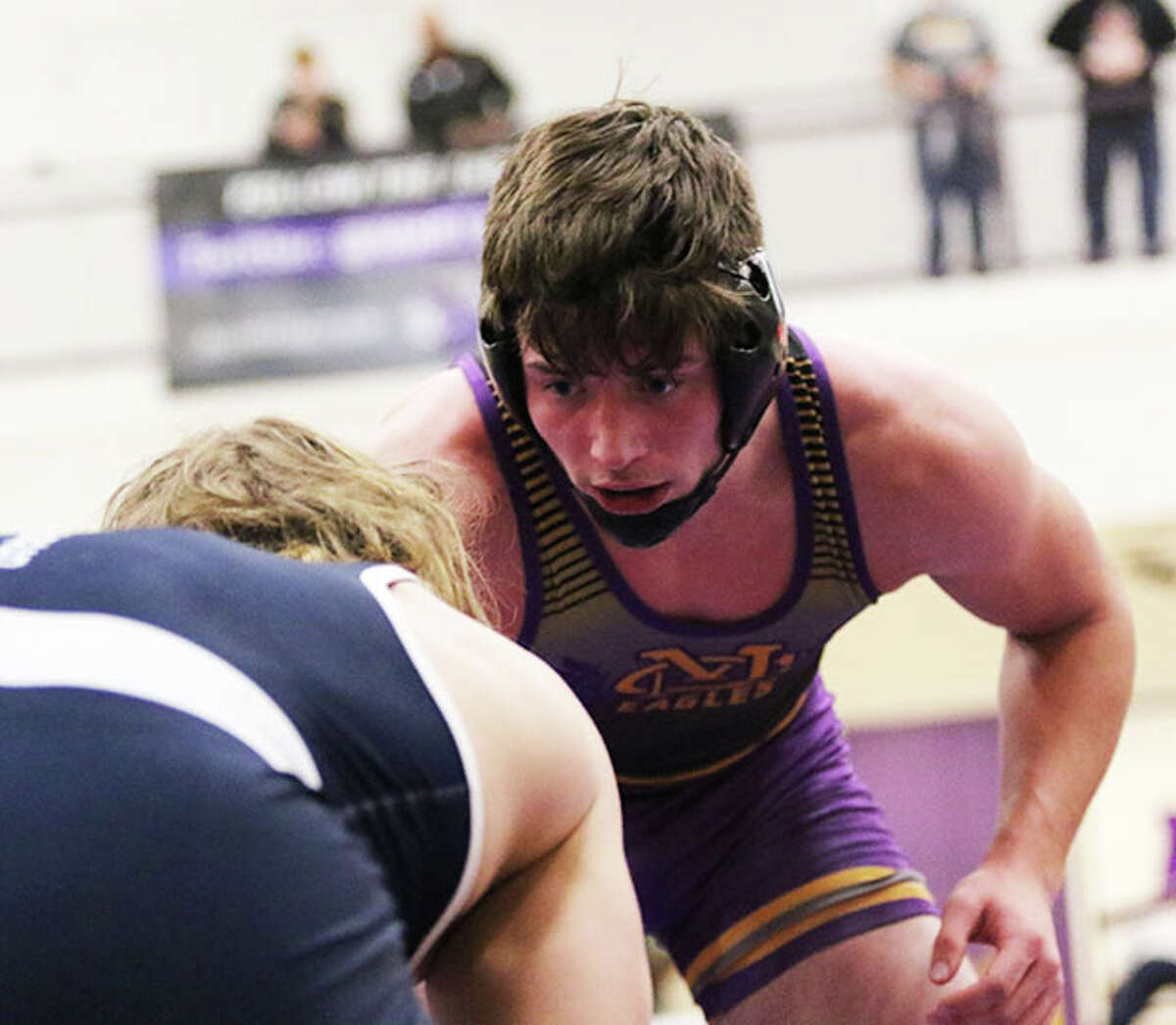 CM senior Colton Carlisle (right) eyes his 182-pound opponent in title bout at the Mascoutah Tourney last month. On Saturday, Carlisle bumped up to 192 pounds and won the title at the Geneseo Tourney to improve his record to 26-2.