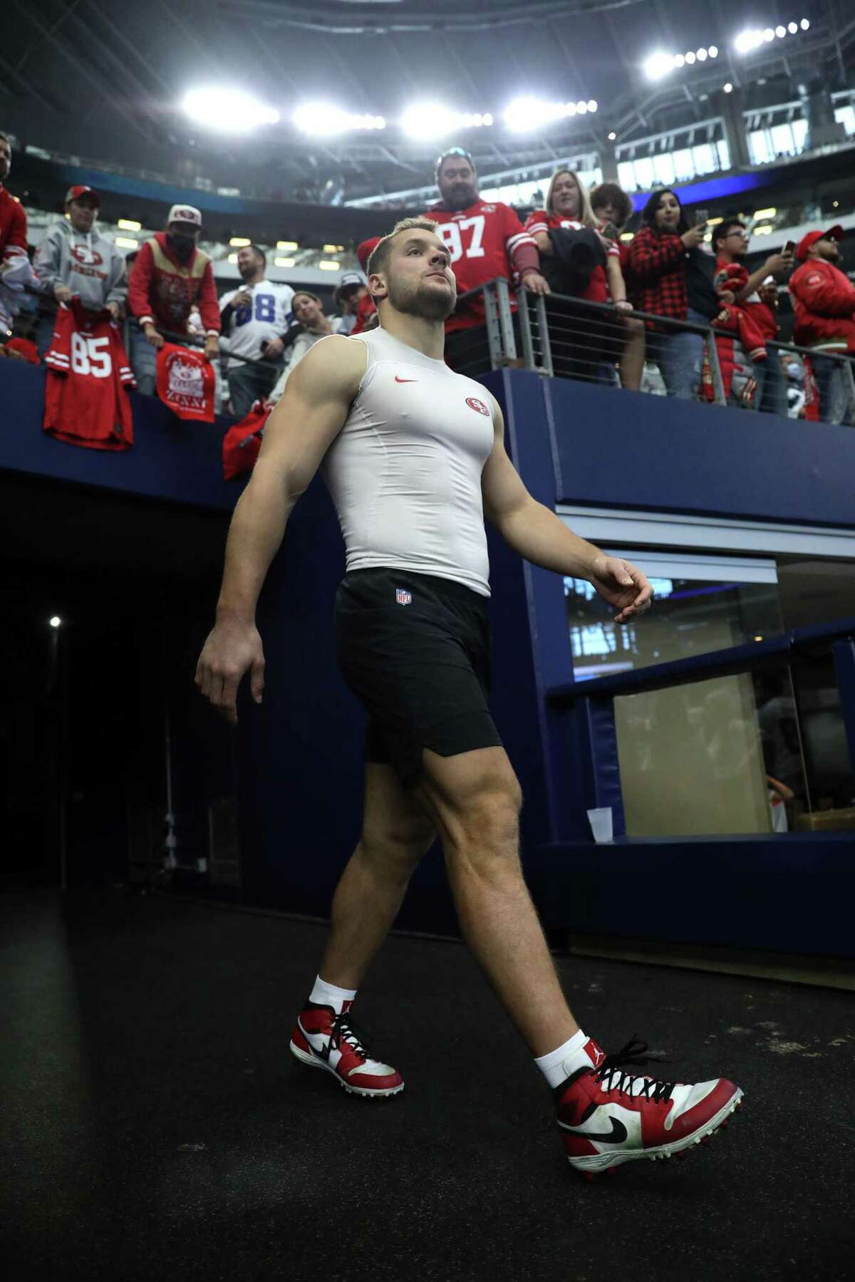 San Francisco 49ers' Nick Bosa walks onto the field before Niners play Dallas Cowboys in NFL NFC Wild Card Playoff game at AT&T Stadium in Arlington, Texas on Sunday, January 16, 2022.