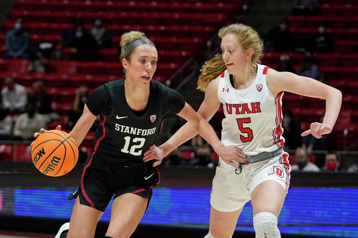 Stanford guard Lexie Hull (12) drives as Utah guard Gianna Kneepkens (5) defends in the first half during an NCAA college basketball game Sunday, Jan. 16, 2022, in Salt Lake City. (AP Photo/Rick Bowmer)