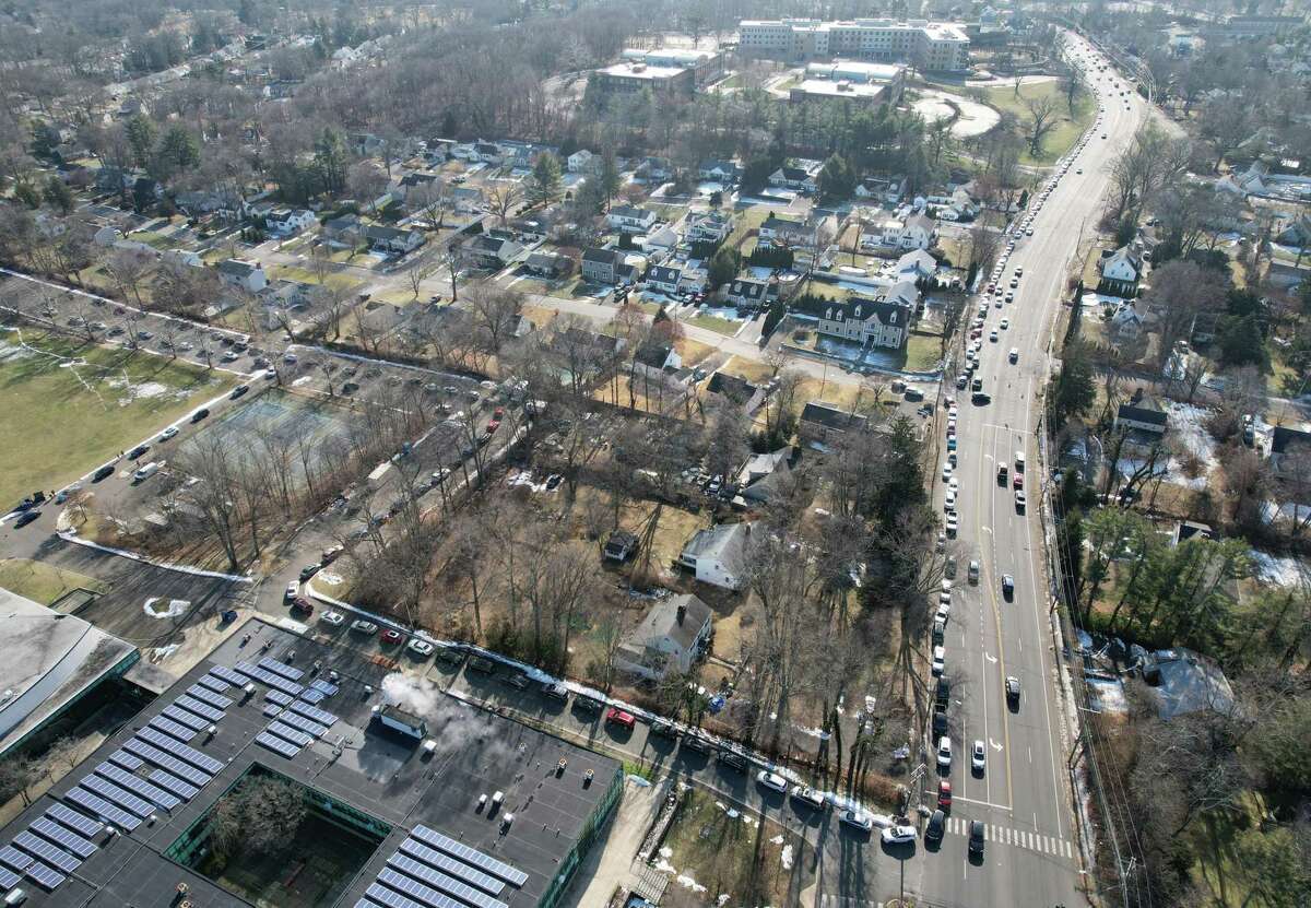 Traffic is backed up as far as the eye can see along High Ridge Road as masks are distributed at AITE High School in Stamford, Conn. Sunday, Jan. 16, 2022. 2,500 five-packs of N95 masks and 2,500 five-packs of surgical masks were distributed to Stamford residents in a drive-thru and walk-up fashion on Sunday.