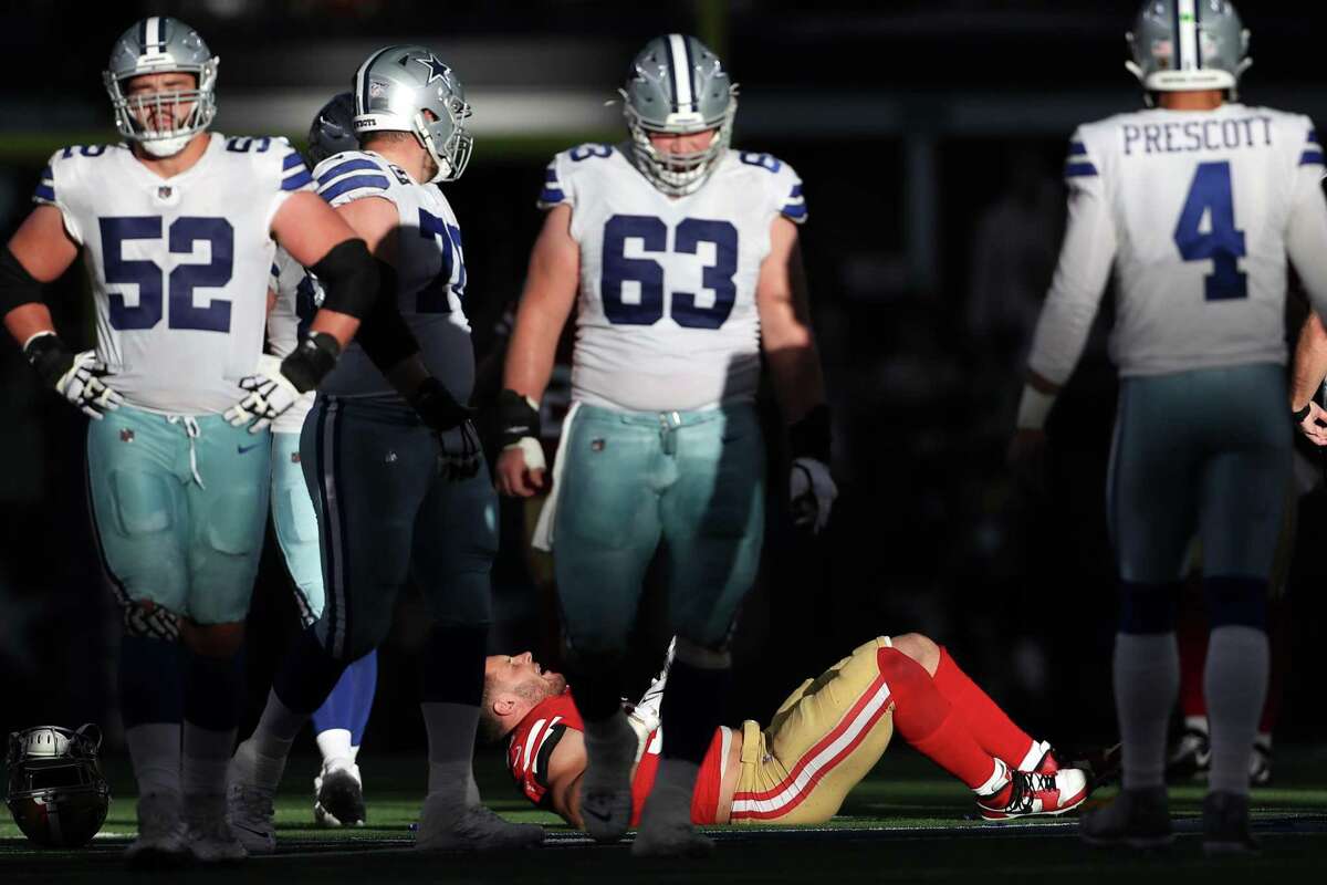 San Francisco 49ers' Nick Bosa is injured in 2nd quarter against Dallas Cowboys during NFL NFC Wild Card Playoff game at AT&T Stadium in Arlington, Texas on Sunday, January 16, 2022.