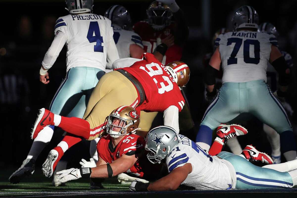 San Francisco 49ers' Nick Bosa is injured by teammate DJ Jones in 2nd quarter against Dallas Cowboys during NFL NFC Wild Card Playoff game at AT&T Stadium in Arlington, Texas on Sunday, January 16, 2022.