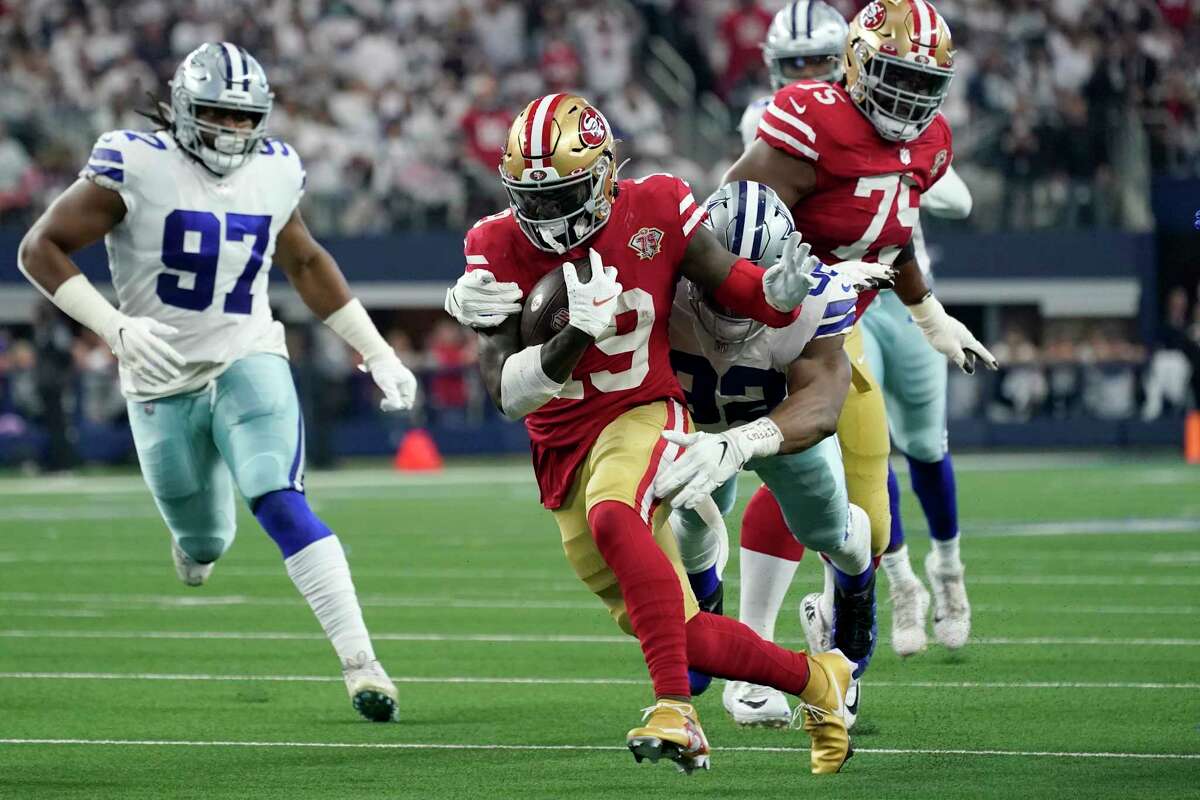 San Francisco 49ers wide receiver Deebo Samuel (19) attempts to escape the grasp of Dallas Cowboys defensive end Dorance Armstrong (92) as defensive tackle Osa Odighizuwa (97) moves in to help make the tackle in the first half of an NFL wild-card playoff football game in Arlington, Texas, Sunday, Jan. 16, 2022.